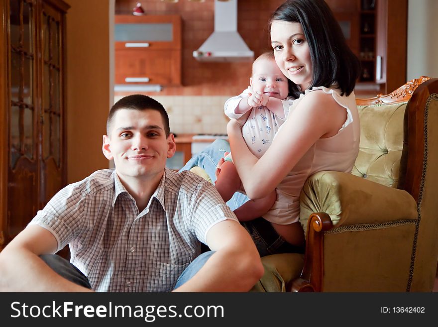 Adorable baby, father and mother in home. Adorable baby, father and mother in home