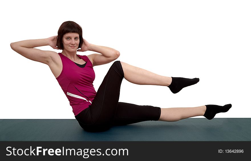 Beautiful young woman doing exercises. White background.