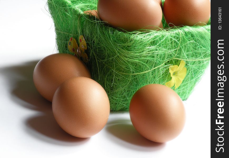 Eggs in and out of green basket