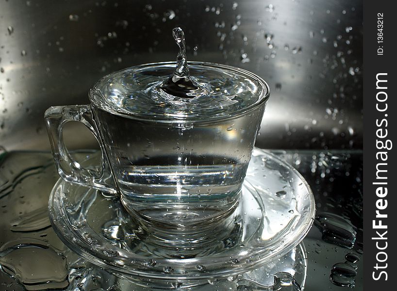 Water splashes in a transparent cup. Water splashes in a transparent cup