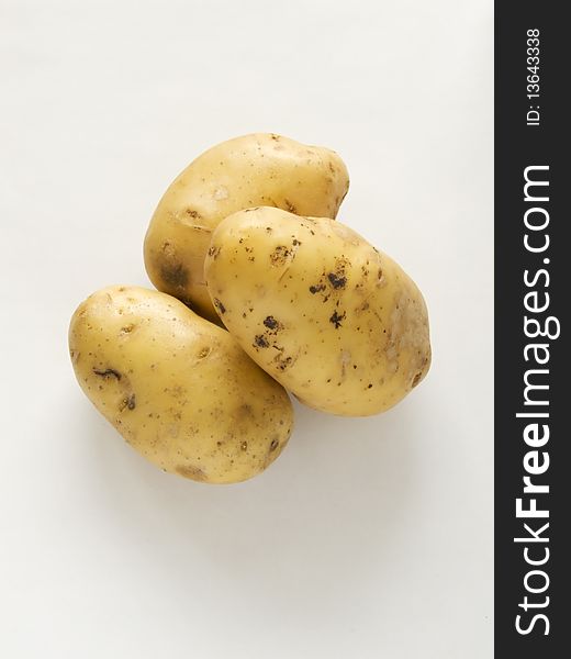 Three potatoes on a white background