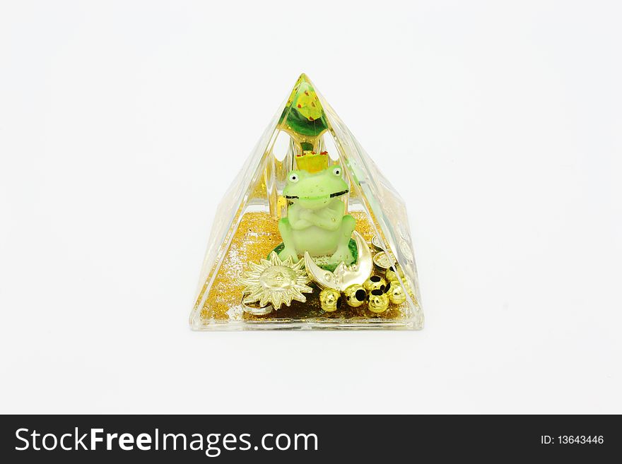 Souvenir- a pyramid from an organic glass with water and a frog inside. Souvenir- a pyramid from an organic glass with water and a frog inside.