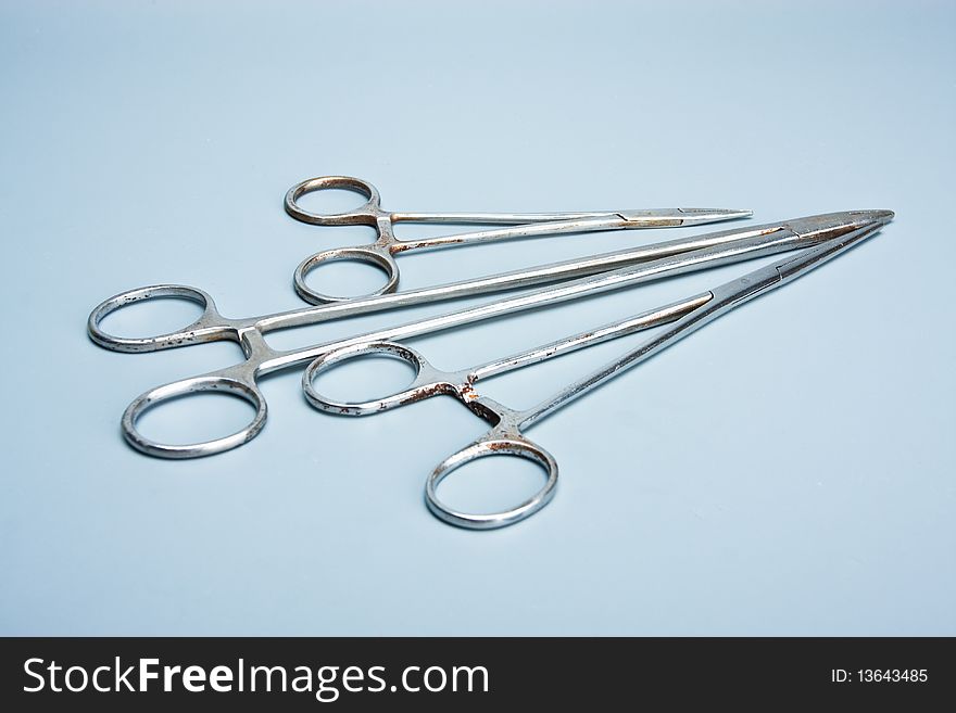 Surgical tools on a light blue background