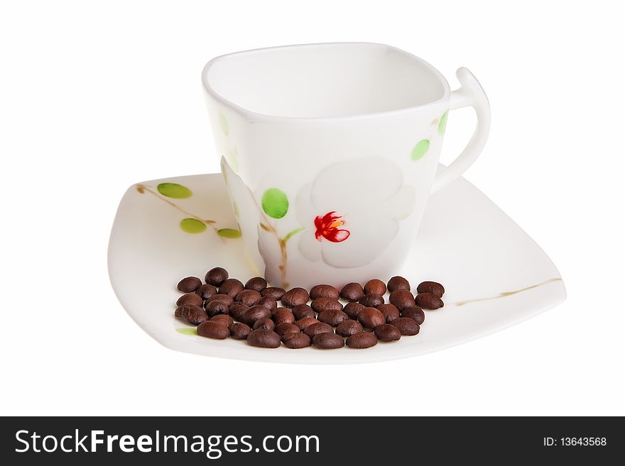 White cup with coffee beans on saucer isolated over white background. White cup with coffee beans on saucer isolated over white background.