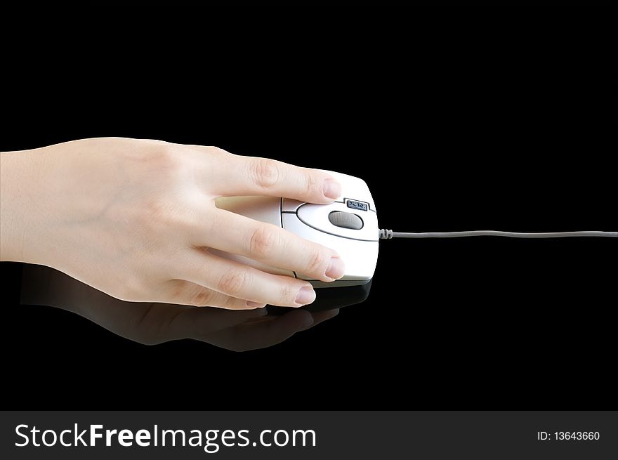 Computer mouse in hand on a black background