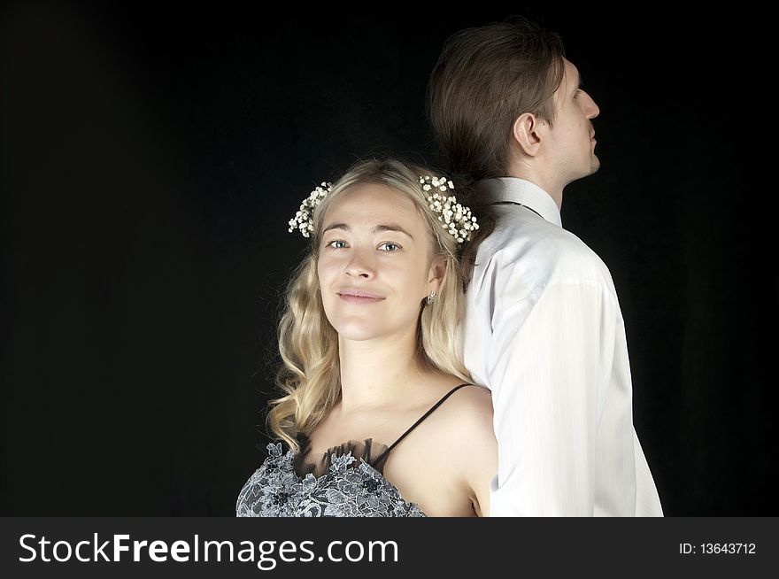 Happy bride and groom posing together in studio