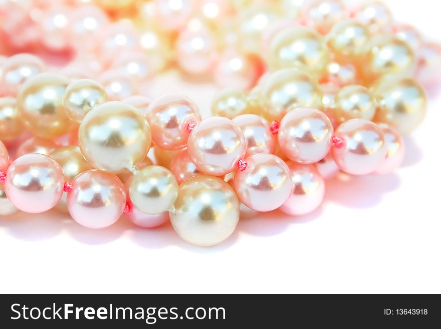 Pink and yellow  beads necklace isolated on white background.