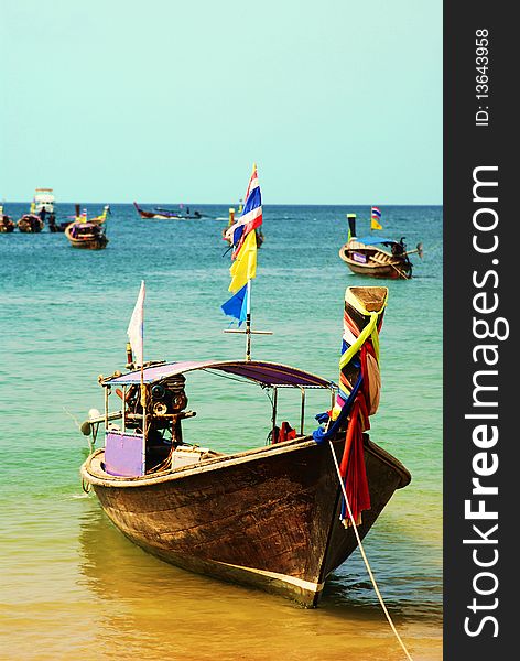 A longboat docked by the shore waiting for distant travelers to take it on another sea worthy adventure. A longboat docked by the shore waiting for distant travelers to take it on another sea worthy adventure.