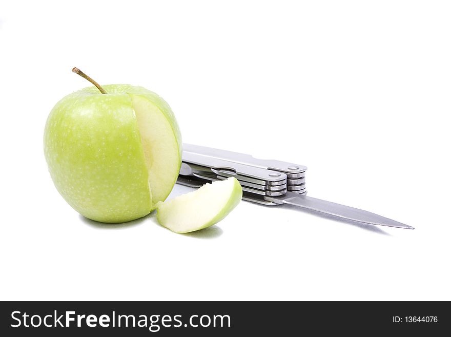 An apple with a segment cut away from it and a locknife isolated on a white background. An apple with a segment cut away from it and a locknife isolated on a white background