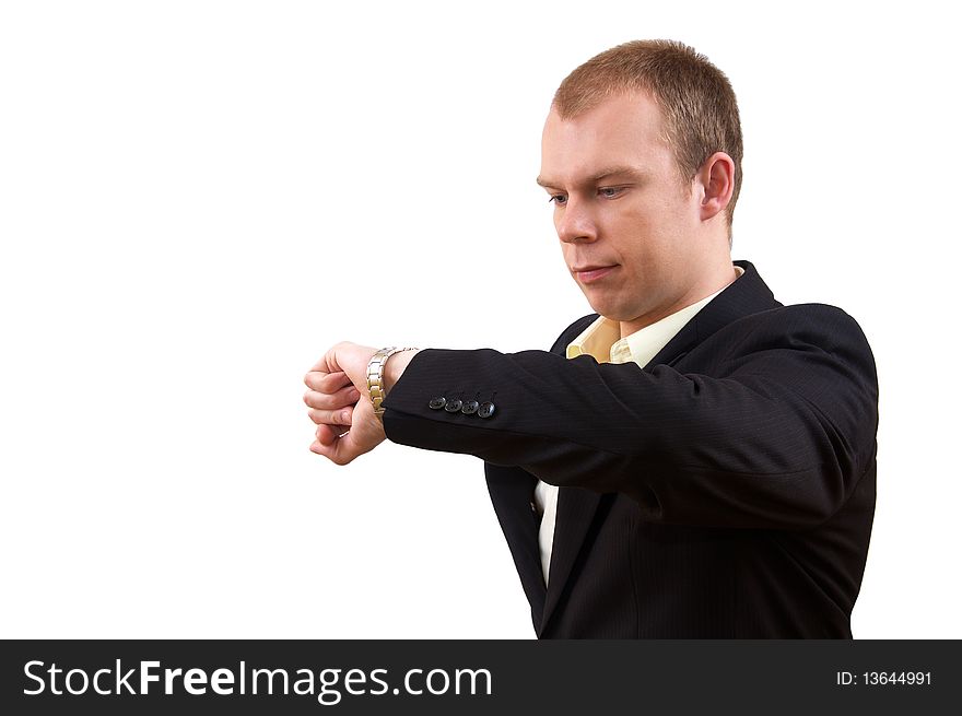 Young businessman in suit looking at watch, on white background. Young businessman in suit looking at watch, on white background