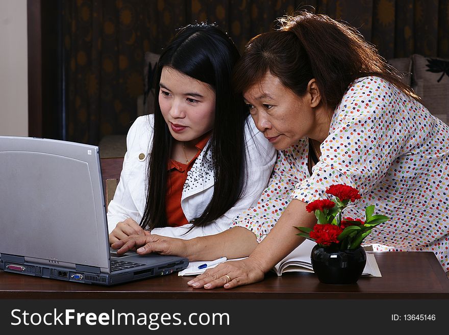 Two woman discussing business internet. Two woman discussing business internet