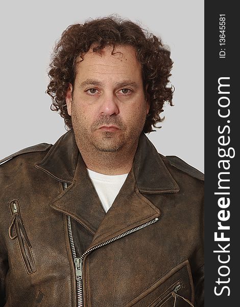 Head shot of male model dressed as a biker in a leather jacket. Head shot of male model dressed as a biker in a leather jacket