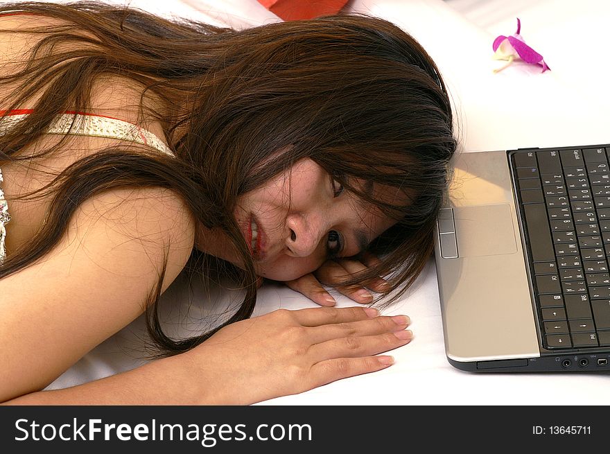 Woman tired using laptop shopping online. Woman tired using laptop shopping online