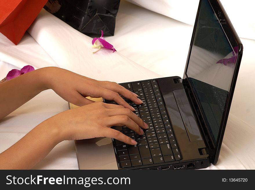 Hands using laptop shopping online