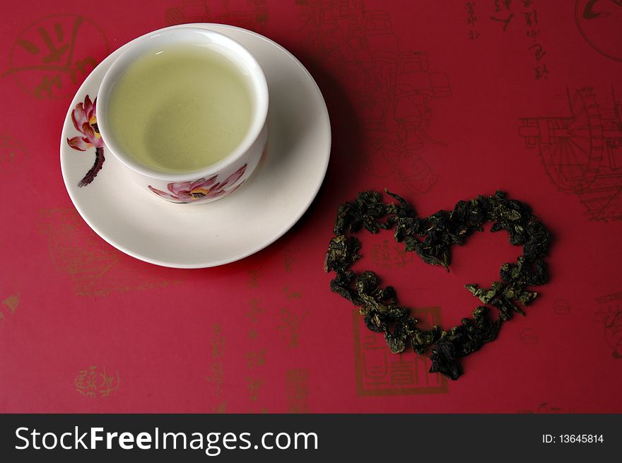 Green tea in a cup on a red background