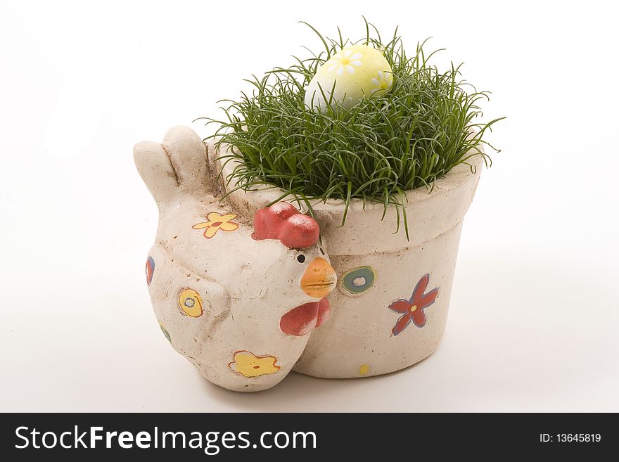 Clay pot in the shape of chicken with grass and egg on the top. Clay pot in the shape of chicken with grass and egg on the top.