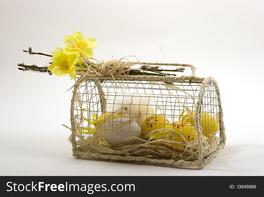 Decoration made of chicken and eggs in small cage with yello roses on the top. Decoration made of chicken and eggs in small cage with yello roses on the top