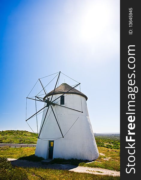 A frontal view of a windmill in action on a sunny day. A frontal view of a windmill in action on a sunny day.