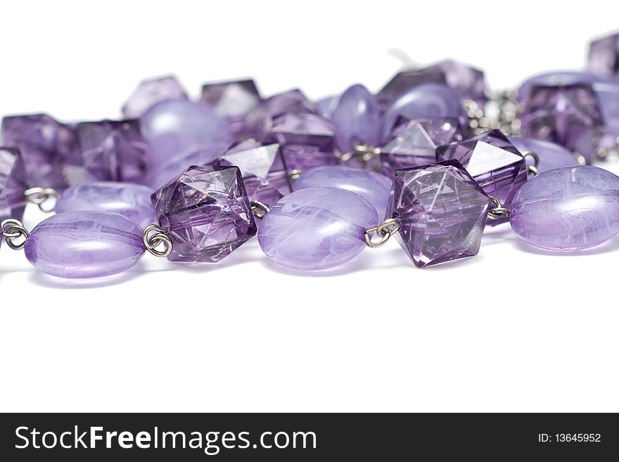 A chain  with purple jewels isolated on white. A chain  with purple jewels isolated on white