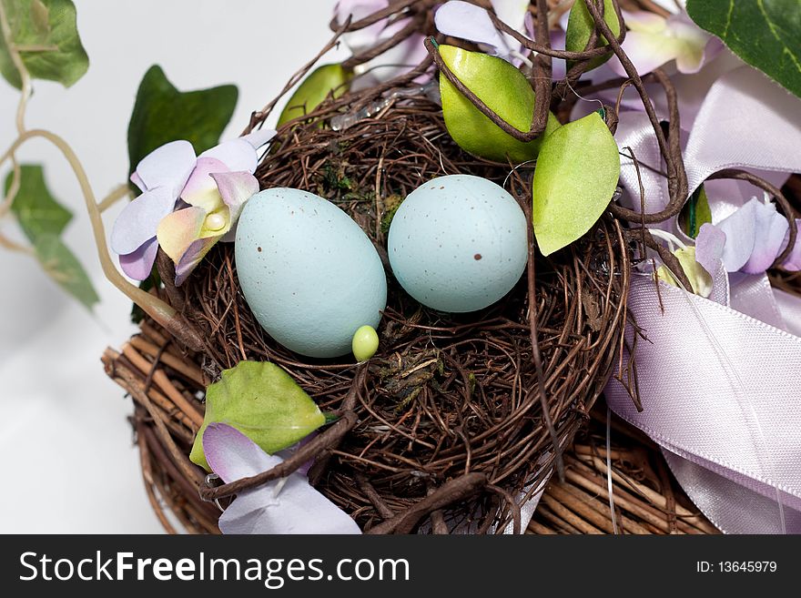 A nest with two blue eggs