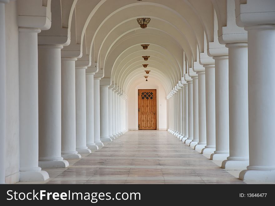 A row of white columns in a romanian monastery. A row of white columns in a romanian monastery