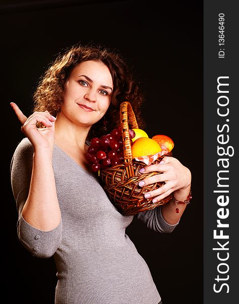 Portrait of young beautiful woman holding fruits in the basket. Portrait of young beautiful woman holding fruits in the basket