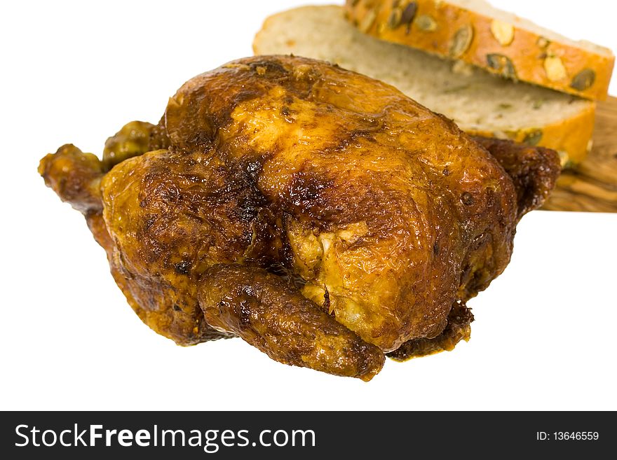 Golden roasted chicken on white plate isolated on