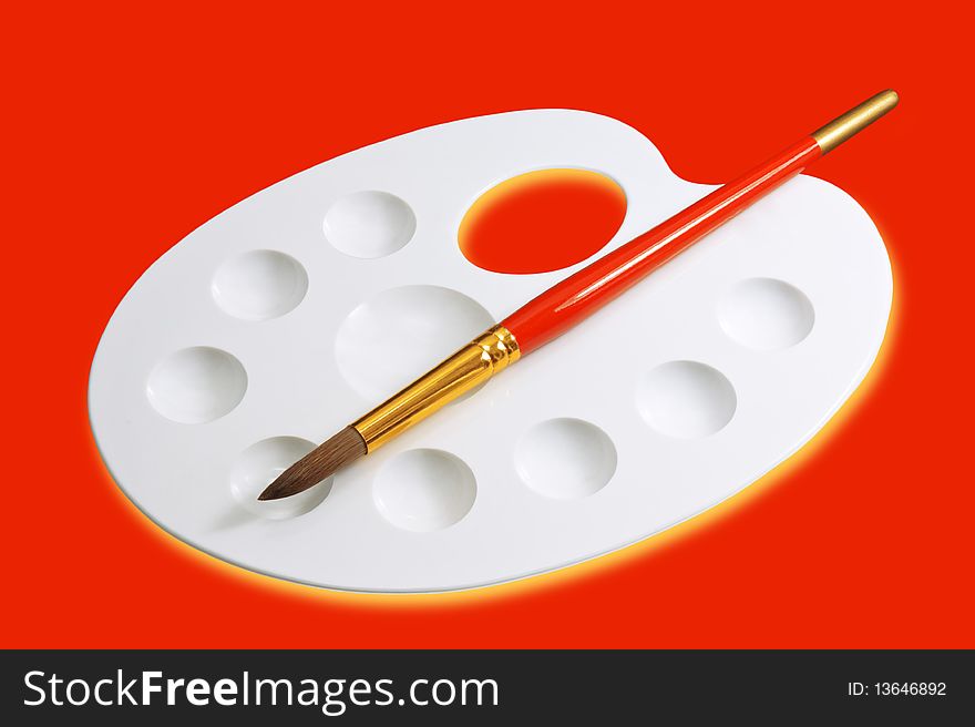 Artist palette and brush isolated on red. Artist palette and brush isolated on red