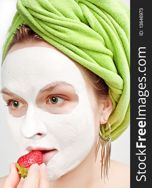 Young women with fase mask and strawberry. Young women with fase mask and strawberry