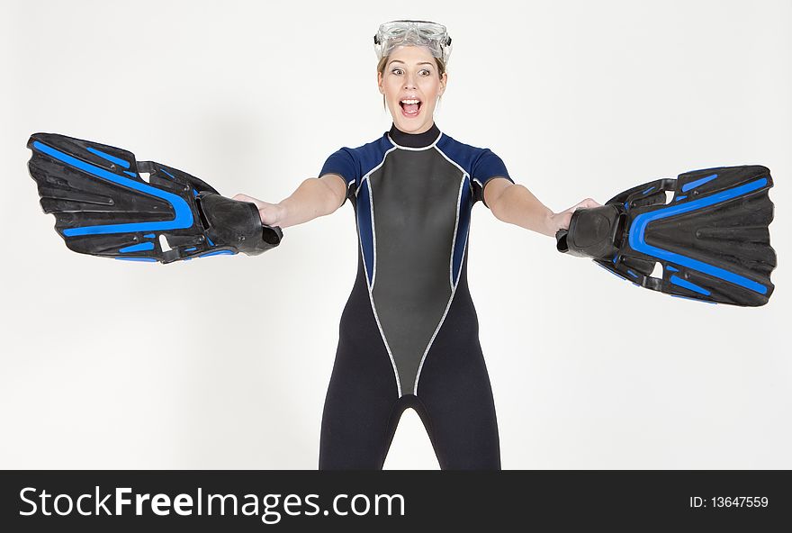 Portrait of woman wearing neoprene with flippers and diving goggles