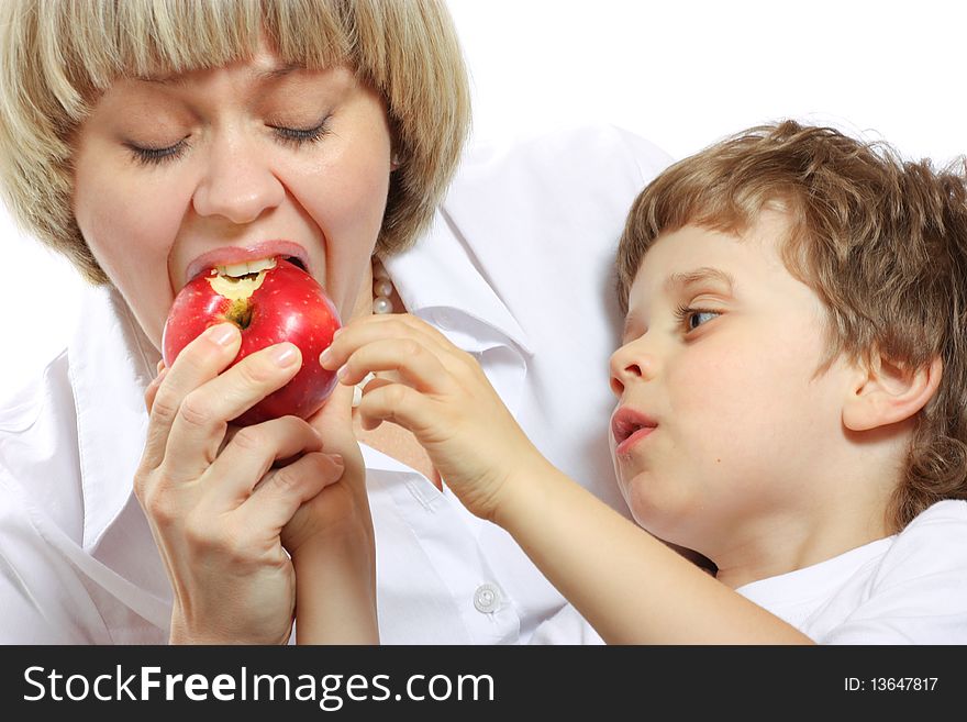 Woman and little boy playing and eating an apple. Woman and little boy playing and eating an apple