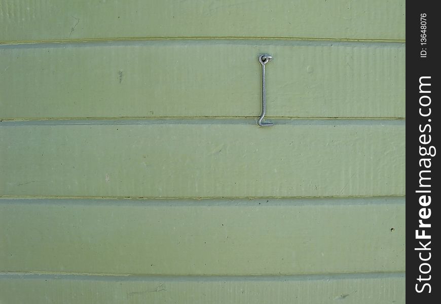 Pale green wooden wall with hasp useful as background. Pale green wooden wall with hasp useful as background.