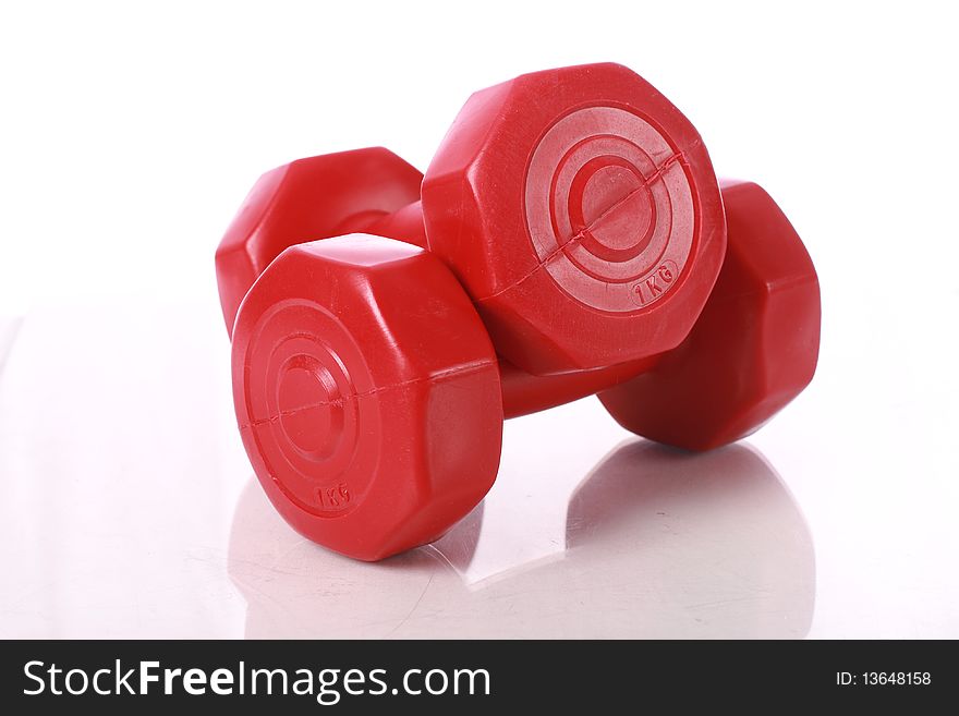 Red dumbbells isolated over white. Red dumbbells isolated over white.