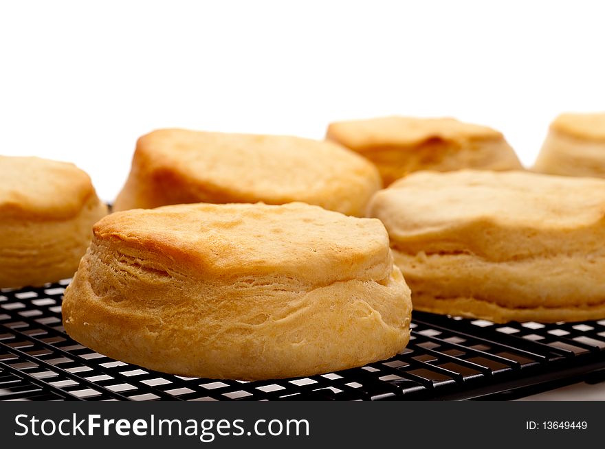 Horizontal close up of fresh baked biscuits on white