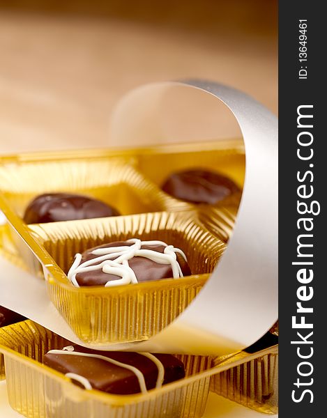A vertical image of two trays of chocolates
