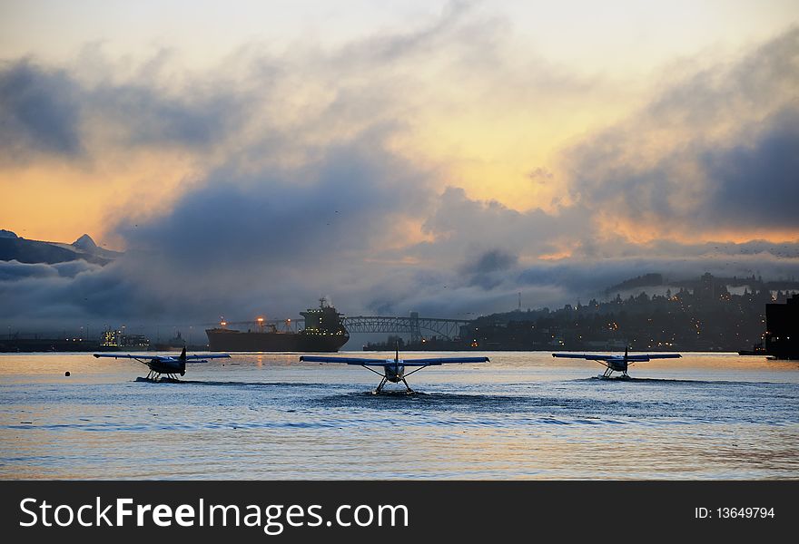 Three small airplanes preparing to take flight in the Burrard Inlet, Coal Harbour, Vancouver, British Columbia. Three small airplanes preparing to take flight in the Burrard Inlet, Coal Harbour, Vancouver, British Columbia.