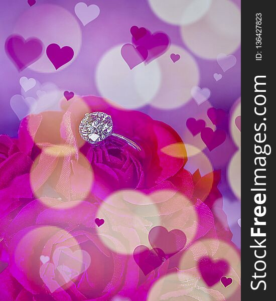 Diamond Ring placed in flowers with a bokeh background and hearts. Isolated. Stock Image. Diamond Ring placed in flowers with a bokeh background and hearts. Isolated. Stock Image