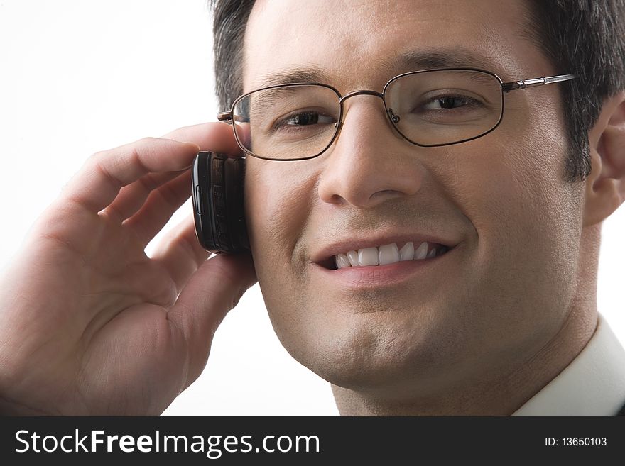 The businessman in points smiles and speaks by a mobile phone