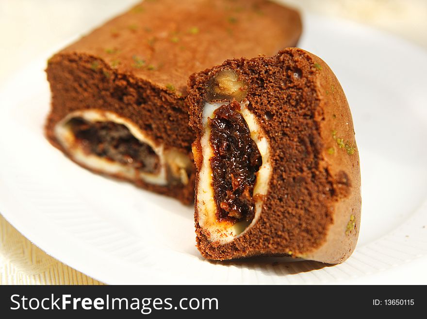 Chocolate cake with raisin and nut inside.