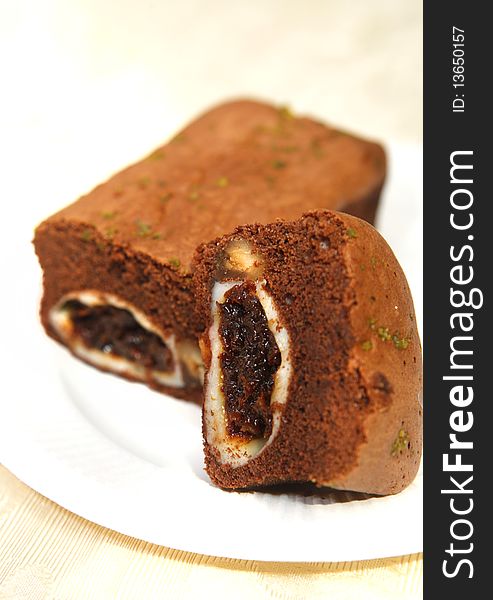 Chocolate cake with raisin and nut inside.