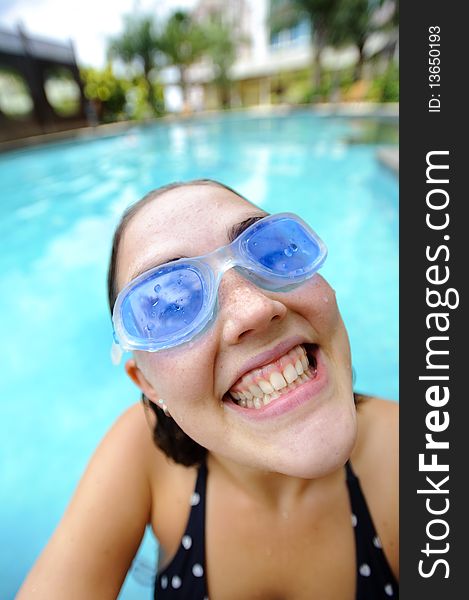 Woman is happy and smiles at the hotel pool. Woman is happy and smiles at the hotel pool