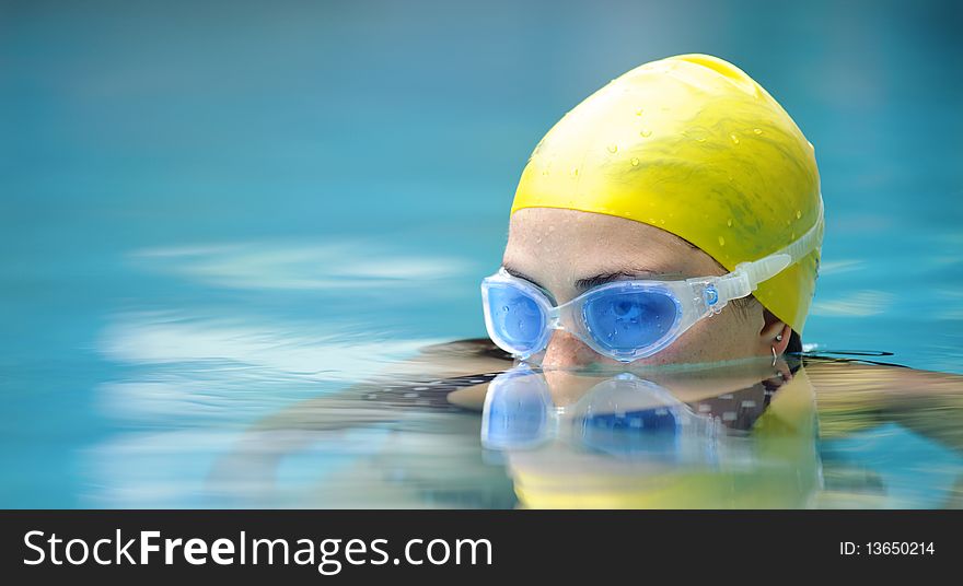 Submerged swimmer looks over the water surface. Submerged swimmer looks over the water surface