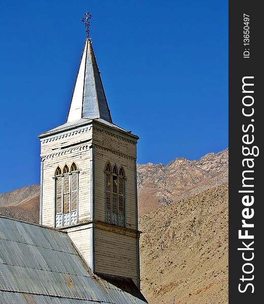 Close up of the bell tower of an ancient church in the mountain.