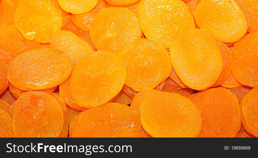 A background of dried yellow and orange apricots. A background of dried yellow and orange apricots