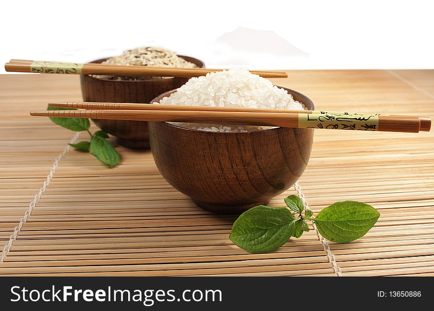 Two bowls with white and brown rice. Two bowls with white and brown rice