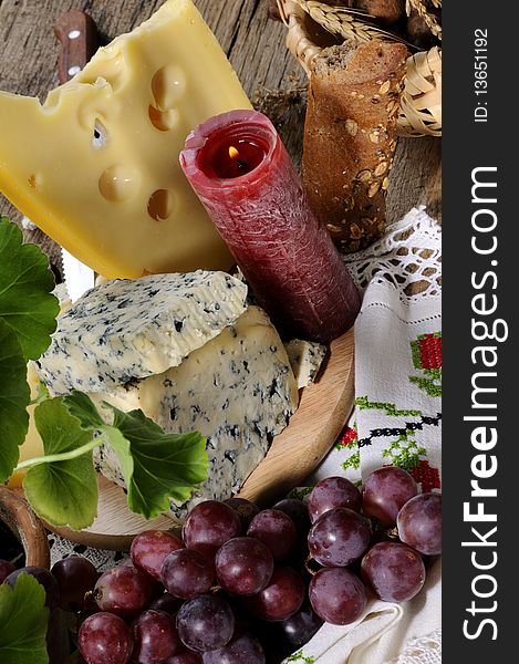 Closeup with blue cheese, fruits studio isolated, traditional towel in background. Closeup with blue cheese, fruits studio isolated, traditional towel in background