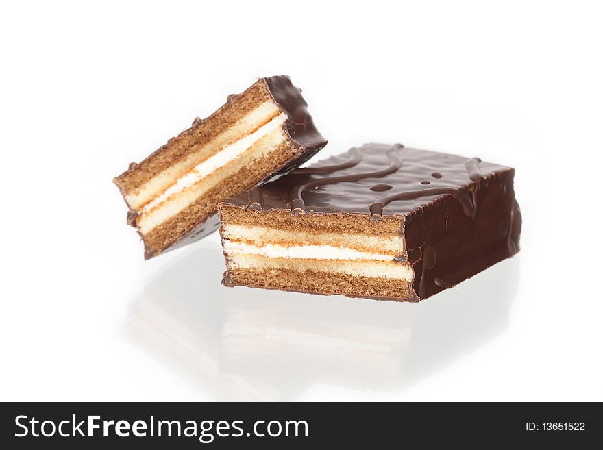 Sliced chocolate cake isolated on white background with reverberation. Sliced chocolate cake isolated on white background with reverberation