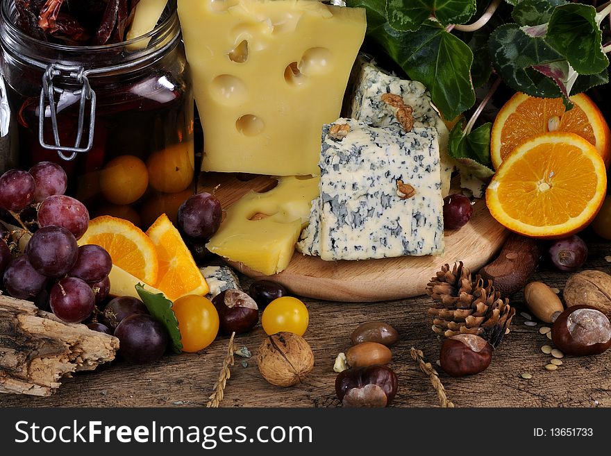 Closeup with fruits, vegetables traditional cheese studio isolated and plants around