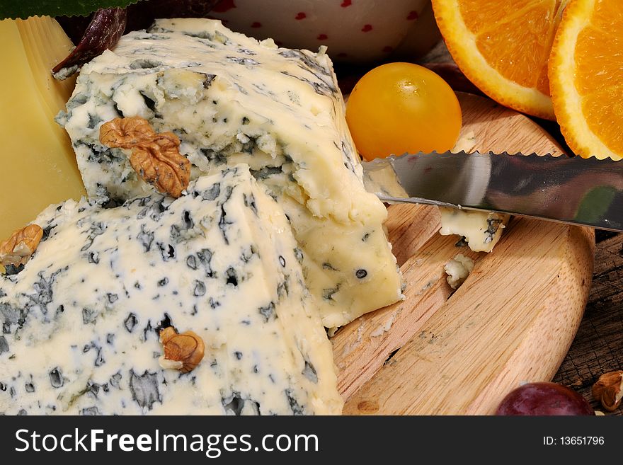 Closeup with fruits, vegetables traditional cheese studio isolated and plants around