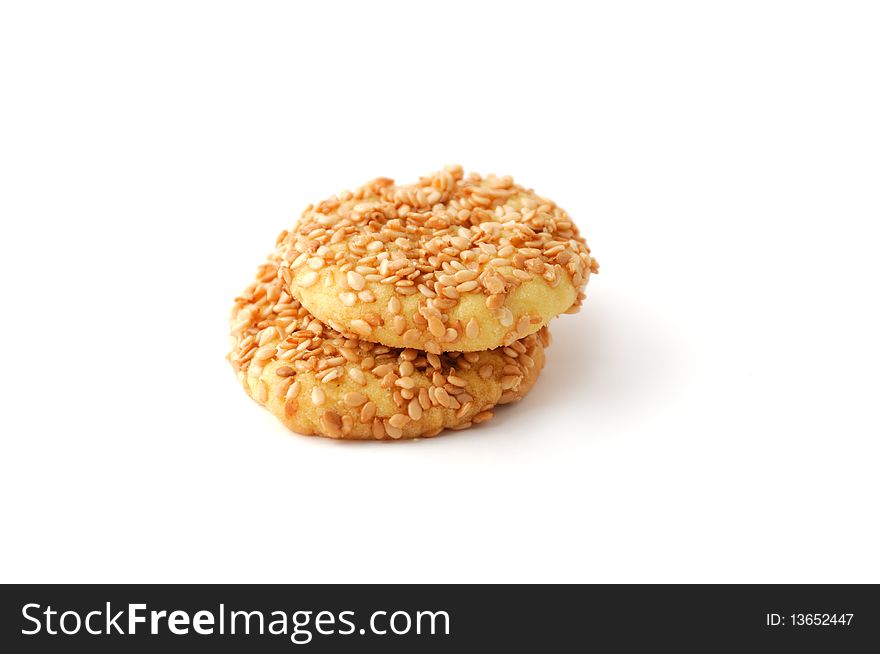 Round cookies covered with sesame seeds isolated on white. Round cookies covered with sesame seeds isolated on white